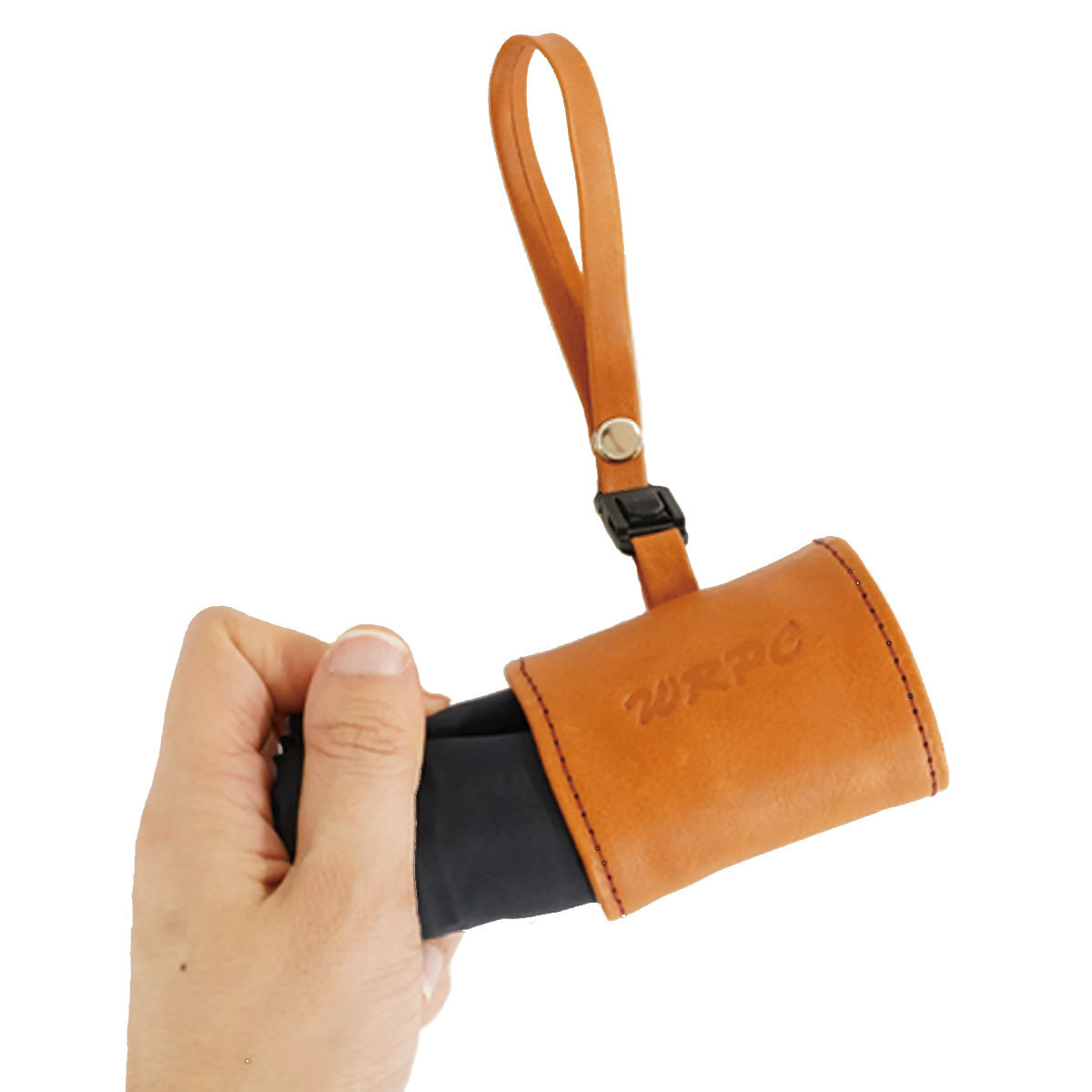 Hand holding a small brown leather holster with a loop strap attached to a black item inside it