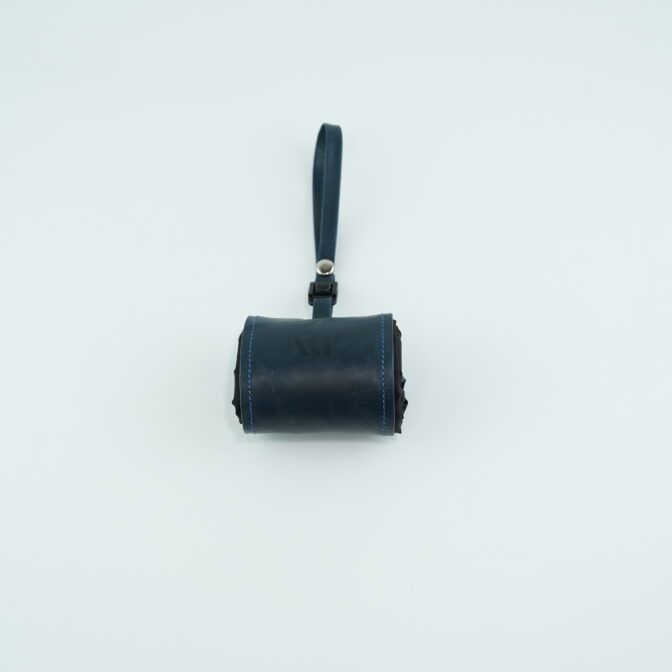 Dark blue leather pouch with a wrist strap, centered on a pale background.
