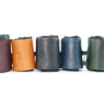 Five colorful leather boot cuffs arranged in a row on a white background (burgundy, tan, dark blue, blue, and green).